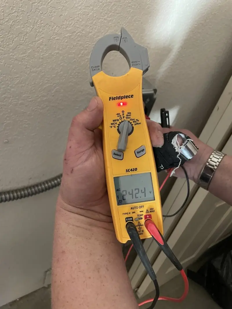 Voltage testing with clamp meter during Recessed Lighting Installation in Wales
